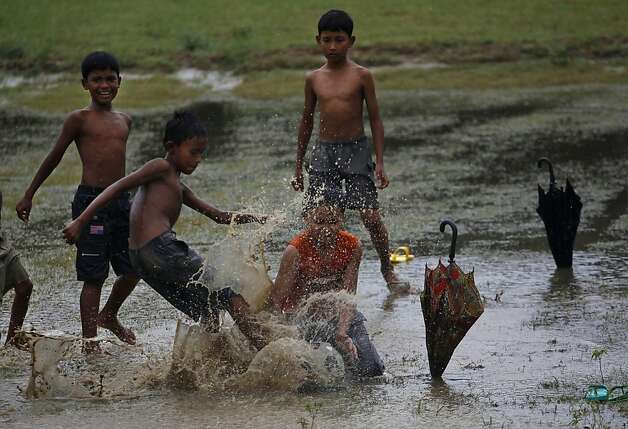 Children Playing Football In Rain