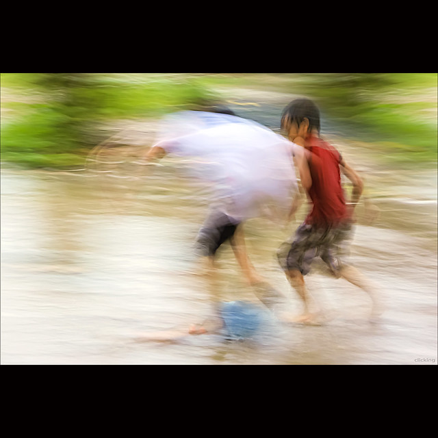 Children Playing Football In Rain